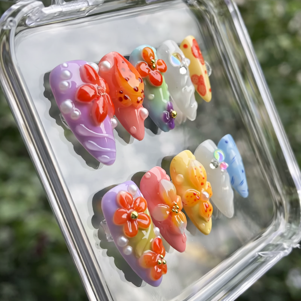 Colorful butterfly-shaped nail art designs in a clear case with a blurred green background