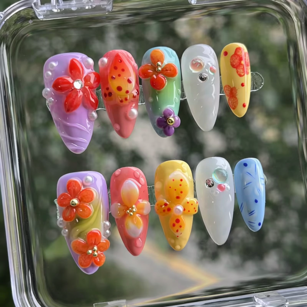 Colorful nail art designs in a clear case with a blurred green background