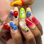 Colorful nail art with fruits and insects on a neutral background