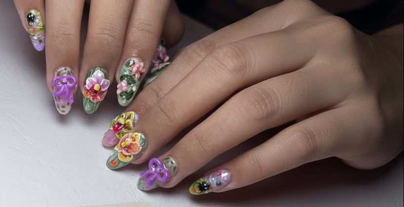 Nails with floral and bow designs on a white background