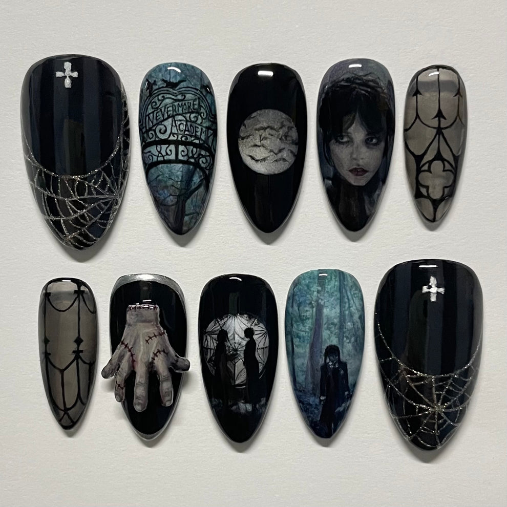 Set of black nail art designs with gothic and horror-themed patterns on a white background.