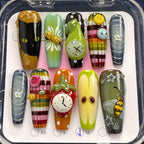 Set of colorful nail art designs in a clear plastic case.