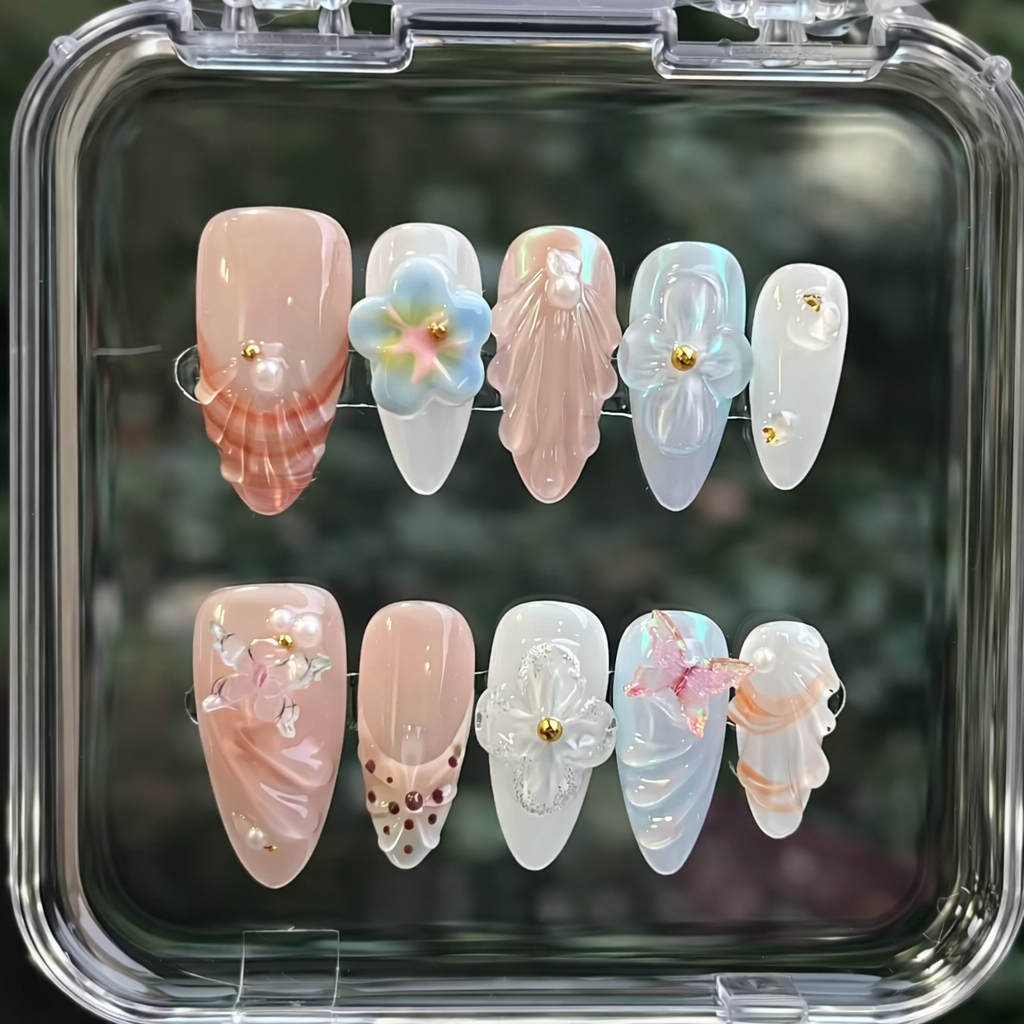Set of decorative false nails in a clear case with a blurred green background