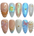 Set of decorative nail art with flowers, butterflies, and pearls on a white background