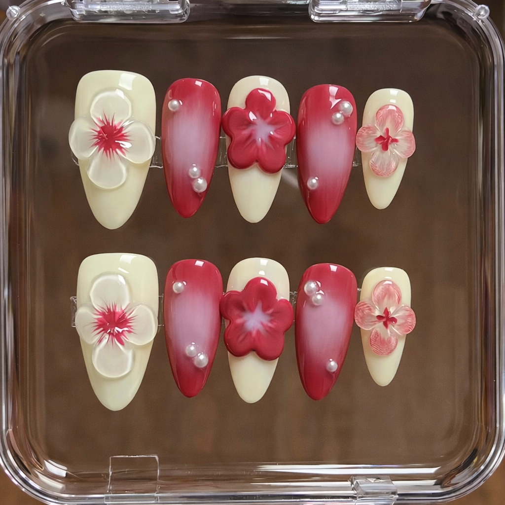 Set of nail art designs with flowers and pearls on a clear tray.