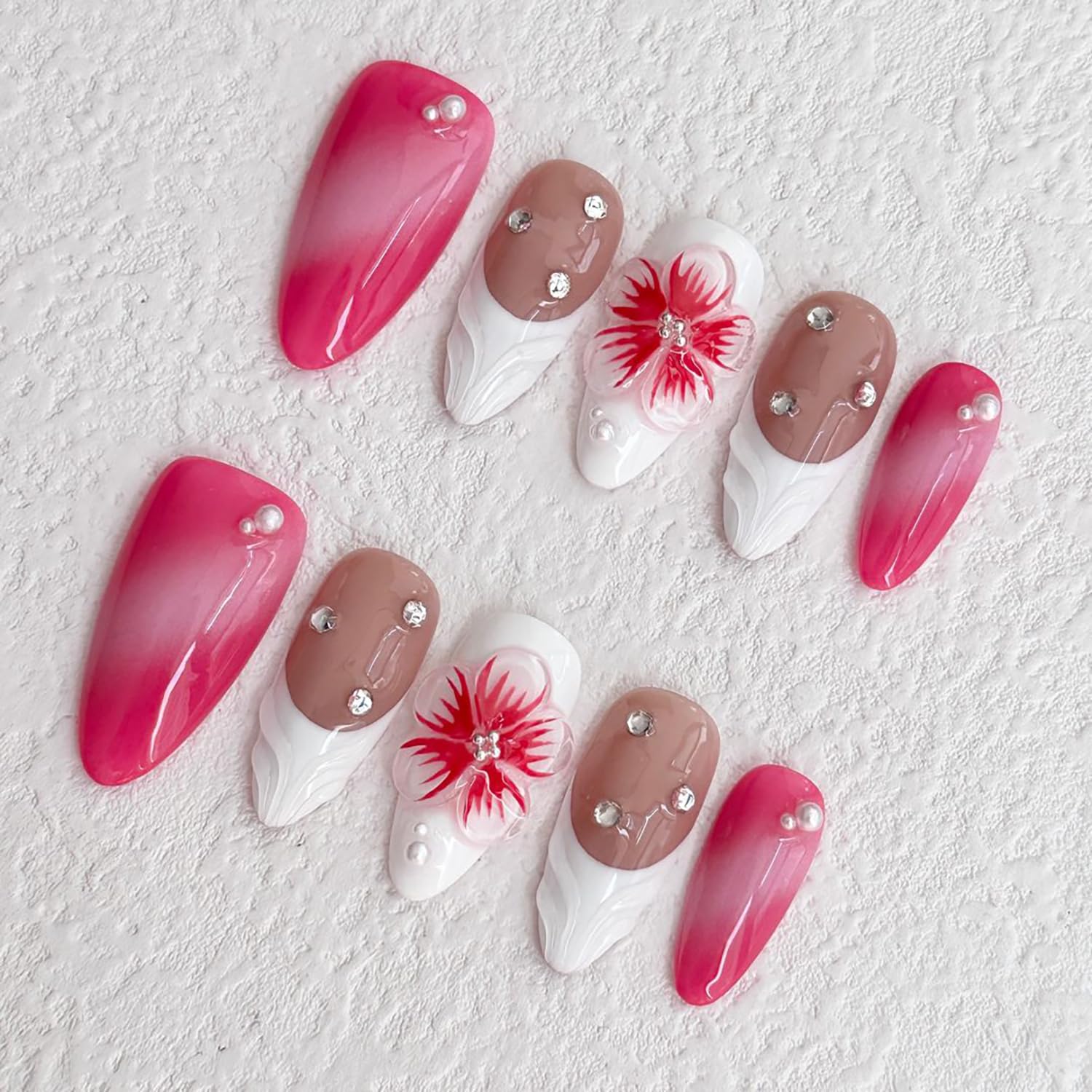 Set of nail art designs with pink, white, and brown colors on a textured white background.