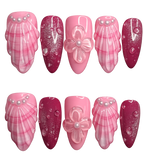 Set of pink and red nail designs with floral and shell decorations on a white background
