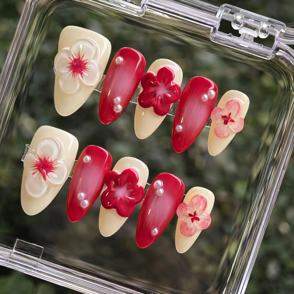 Set of red and beige floral nail art designs in a clear case.