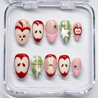 Set of sliced apple nail art designs on clear display with a white background