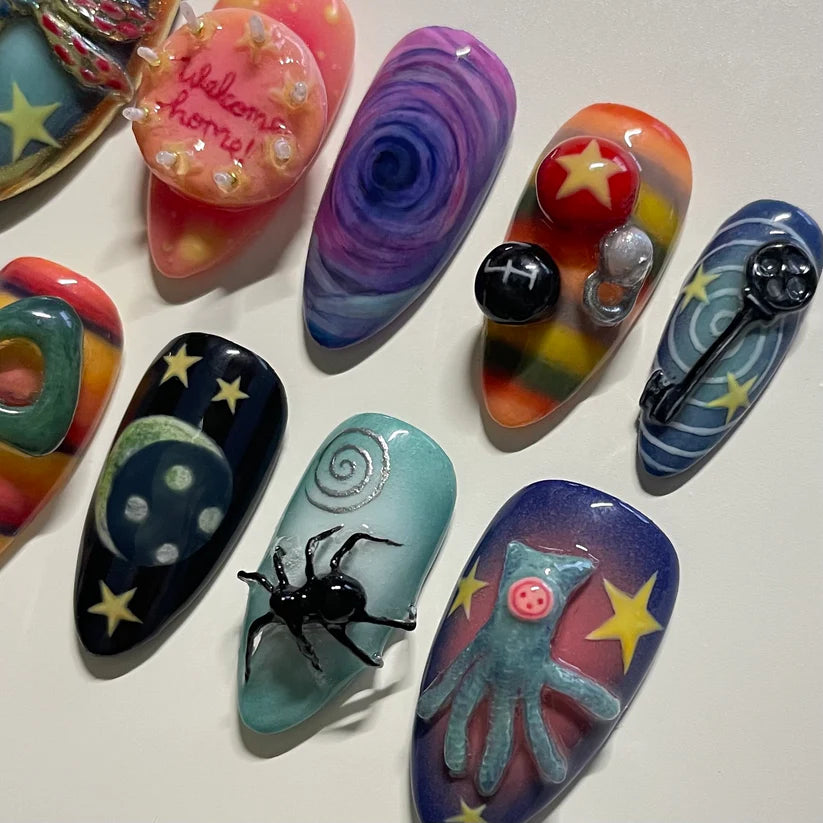 halloween Colorful nail art designs on a white surface